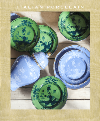 Italian porcelain dishes with green and blue patterns on a wooden surface